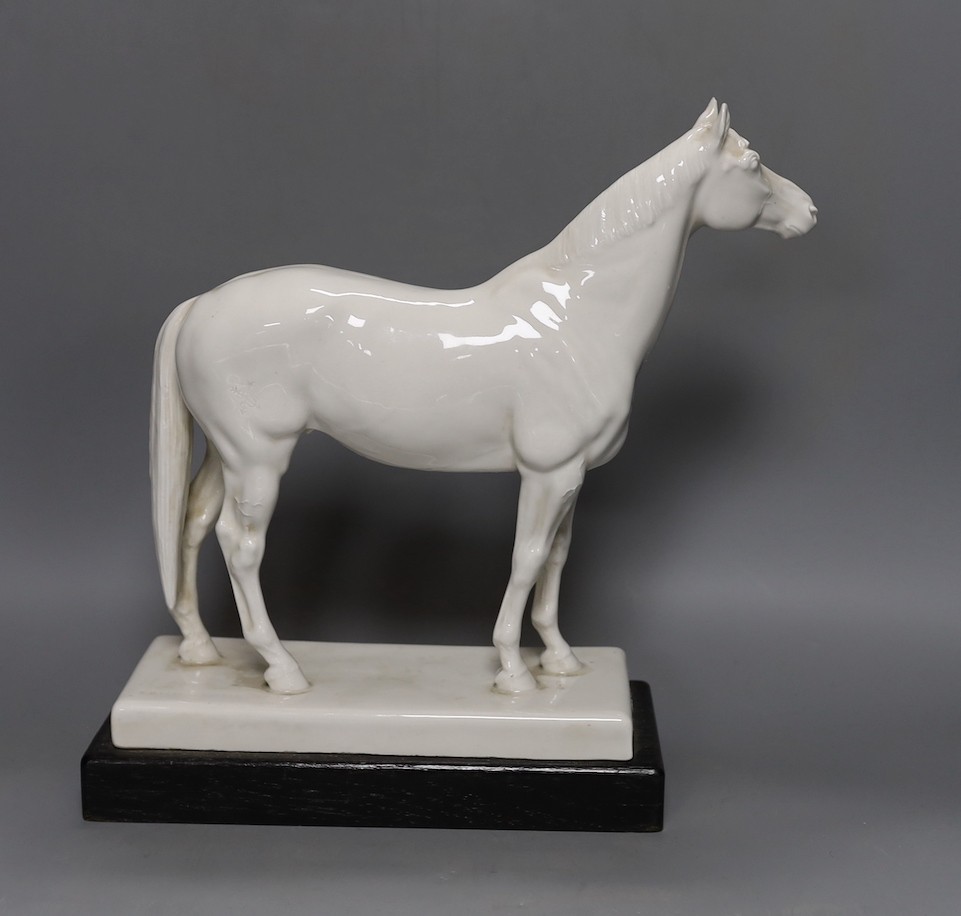 A Meissen model of a horse ‘Alchimist’ signed Erich Oehme 1935, on wooden stand 30cm high, crossed swords mark with to incised lines